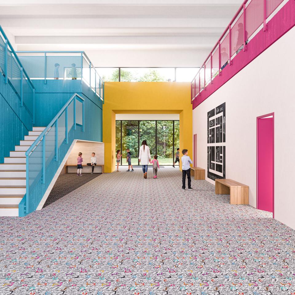 Brightly colored interior with JM Galeote flooring design, showcasing children and adults interacting in a dynamic learning environment.