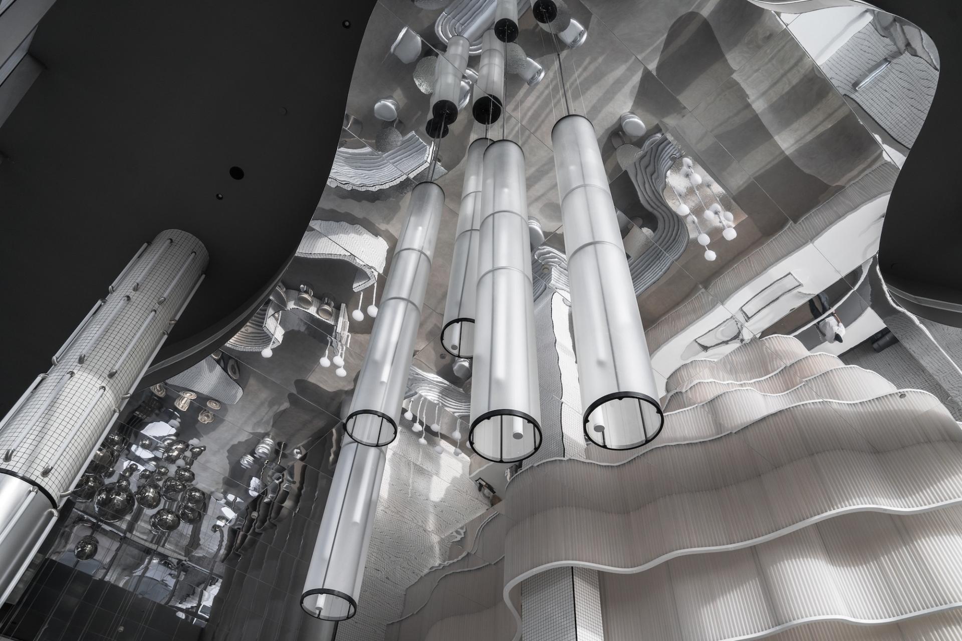 Stylish interior design of MO bakehouse featuring modern lighting and flowing architectural elements in Khobar, Saudi Arabia.