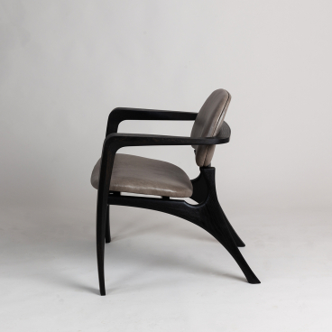 Modern designer chair with sleek black wooden frame and comfortable grey upholstery, highlighting Bristol's creative craftsmanship.