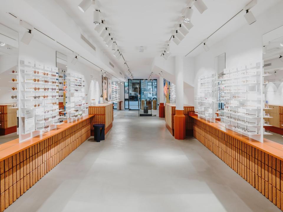Interior of ACE & TATE store in Barcelona, featuring displays of stylish eyewear and sustainable design elements.