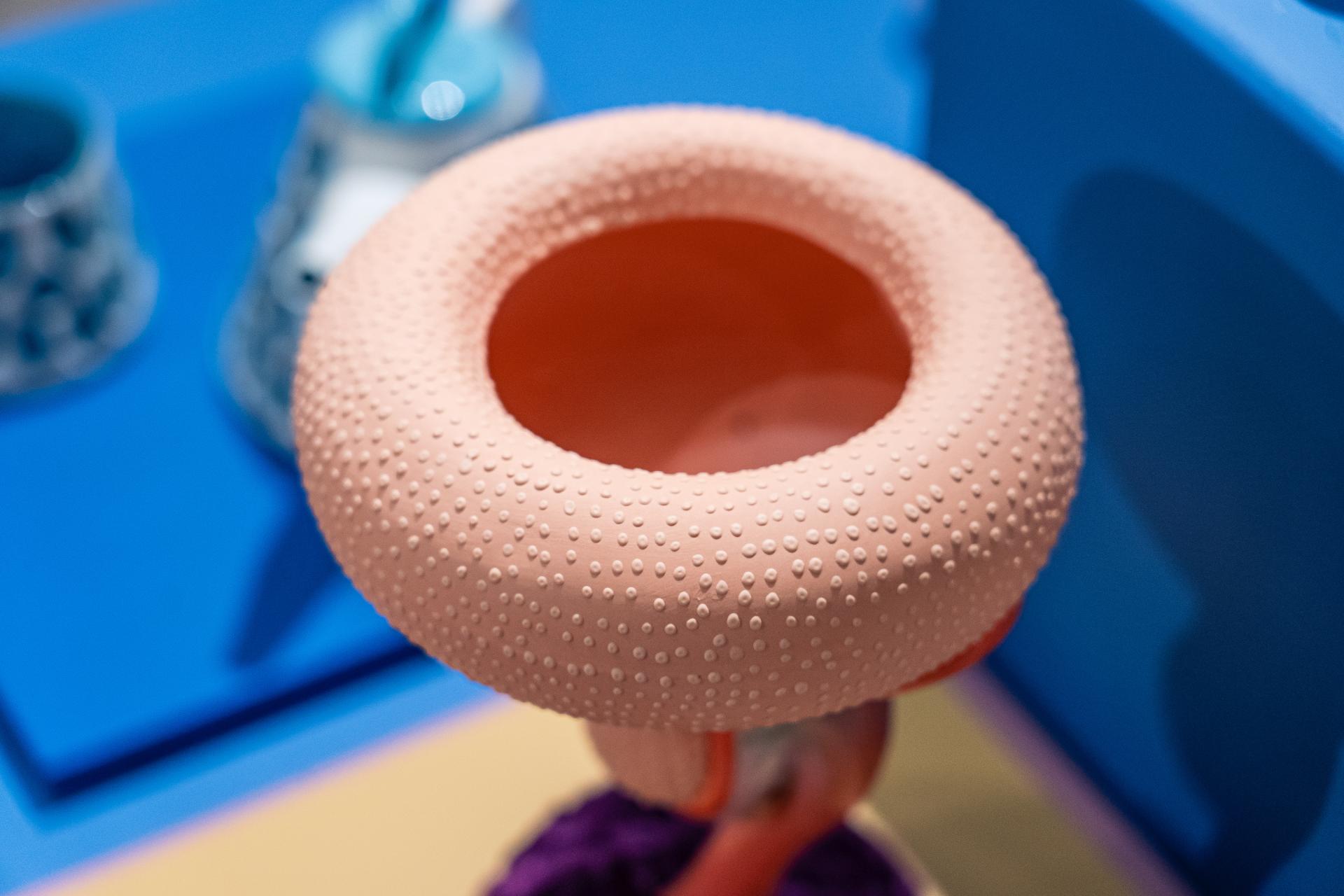 Sculptural ceramic piece with a textured, coral-colored exterior, featured in the Makers in Residence showcase at Material Source Studio Glasgow.