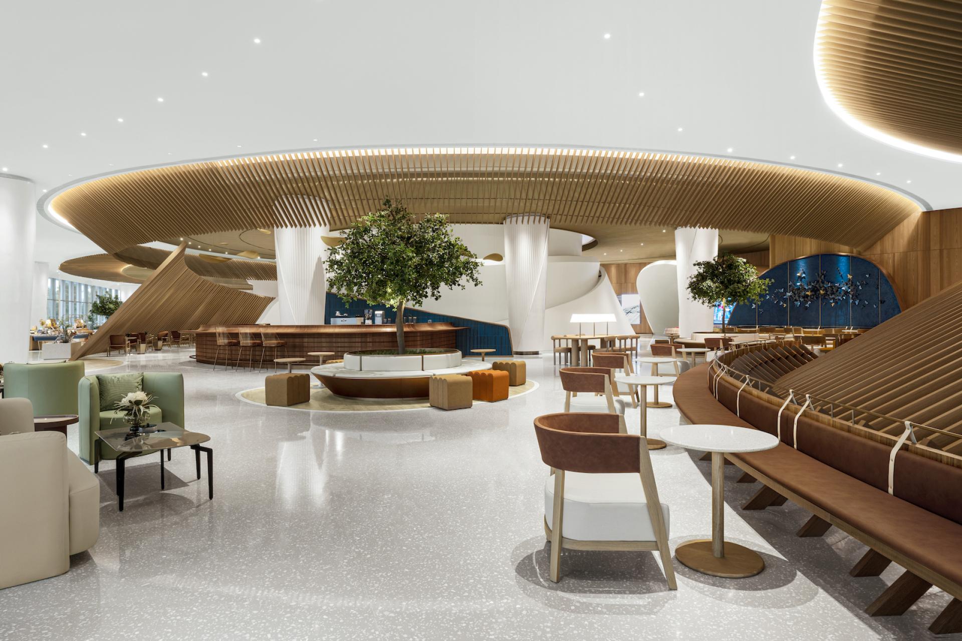 Elegant interior of The Florescence in Guangzhou, featuring sweeping curves, greenery, and a modern, floral-inspired design.