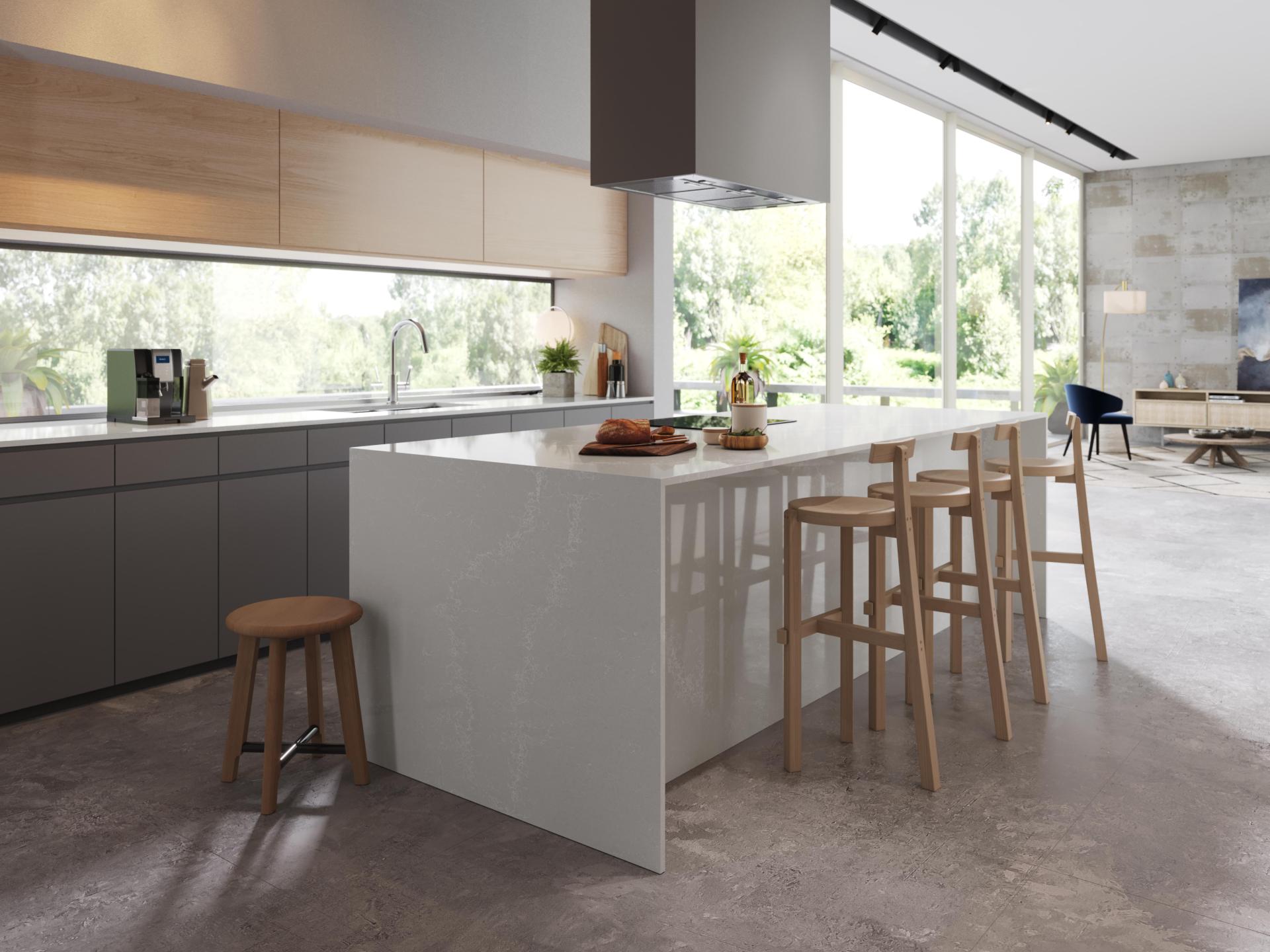 Caesarstone's Alpine Mist surface showcased in a modern kitchen with wooden stools and natural lighting.