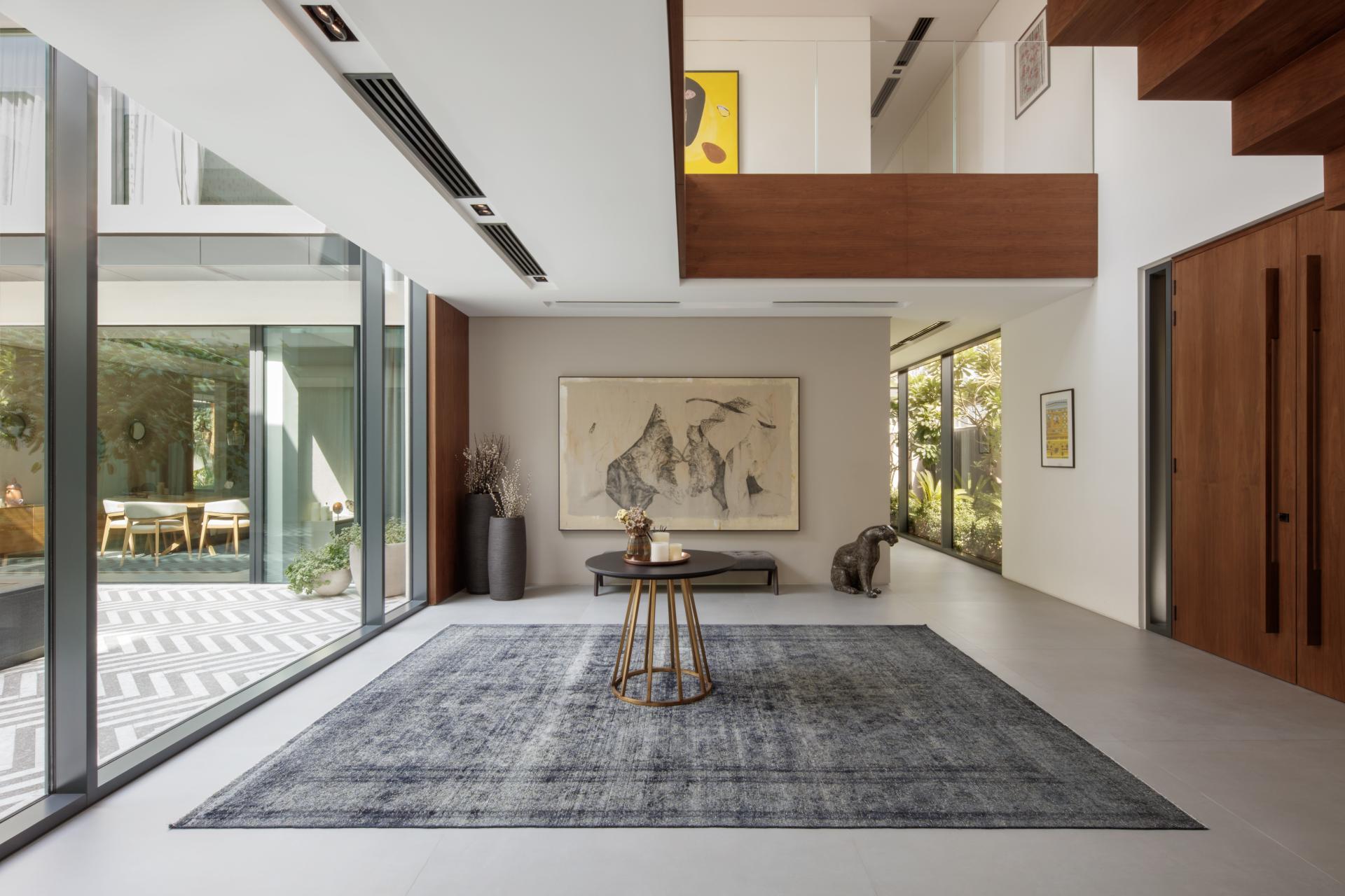 Elegant villa interior featuring a modern design, art pieces, and natural light, creating a tranquil atmosphere.