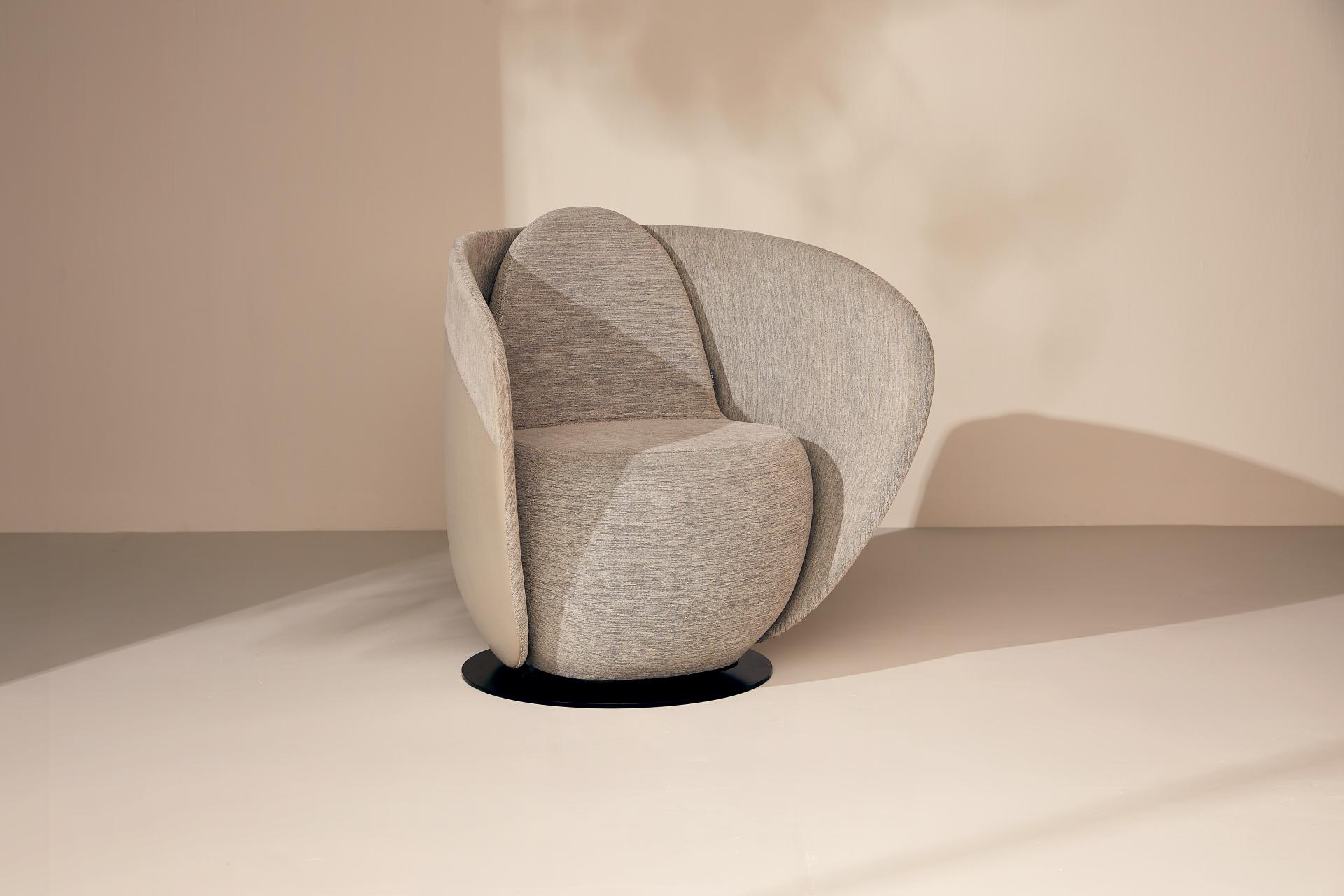 Rounded cocoon chair from Gresham's Relo collection, inspired by sea-smoothed stones, promoting comfort in calming workspaces.