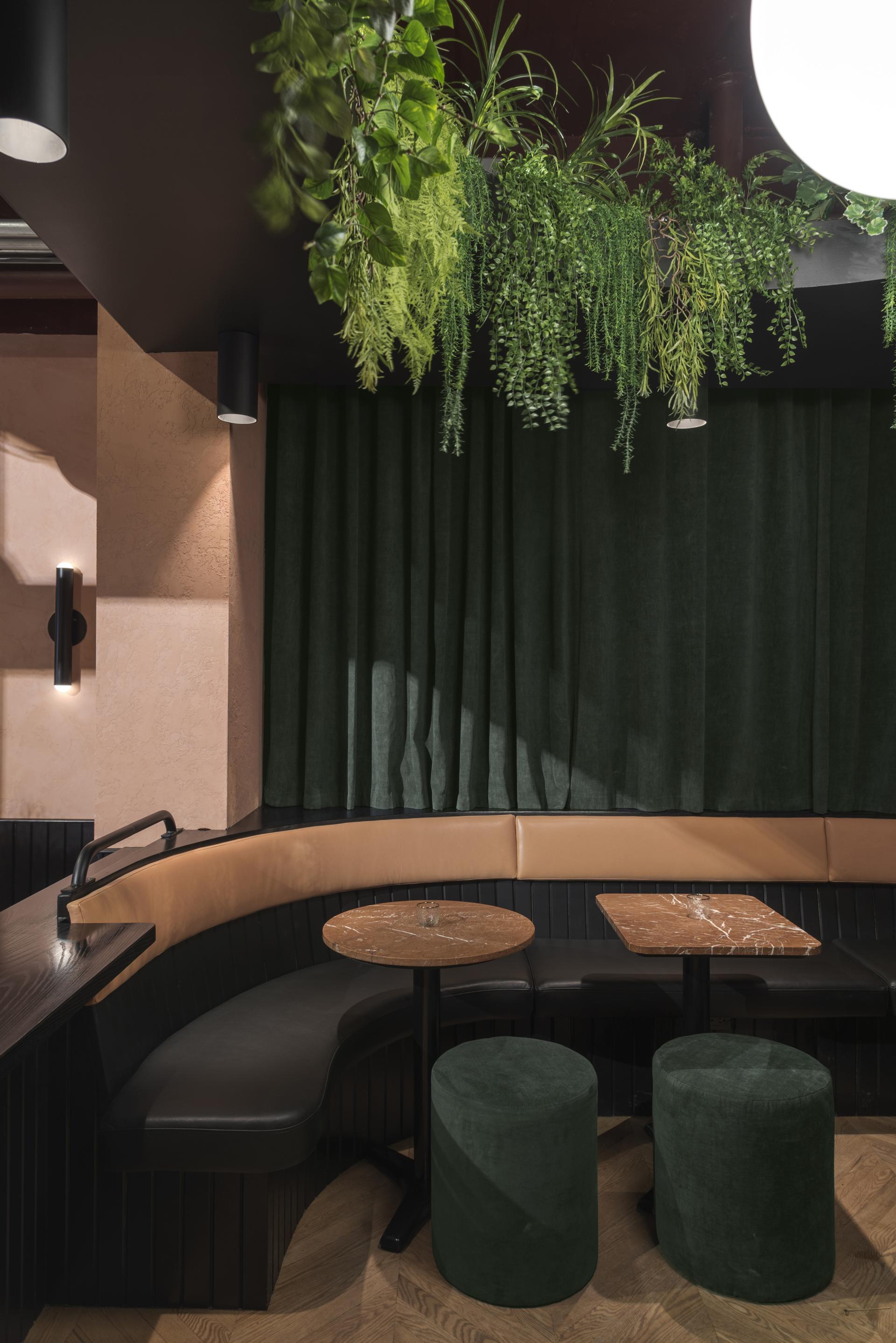Tropical-themed restaurant interior featuring lush greenery, cozy seating, and modern decor in Montreal's vibrant dining scene.