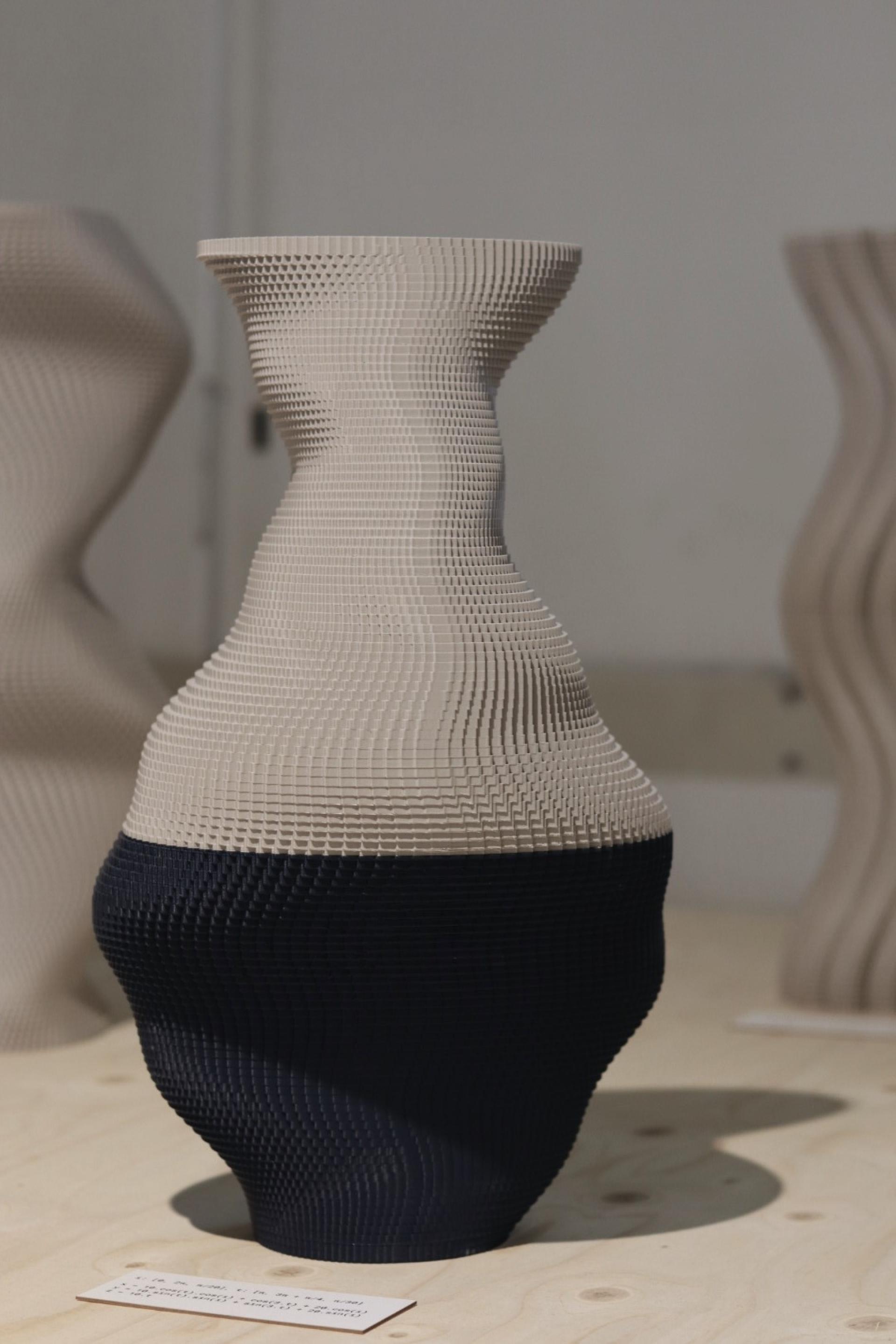 Stylish 3D printed vase featuring a textured design in beige and black, showcasing innovative Dutch design techniques.