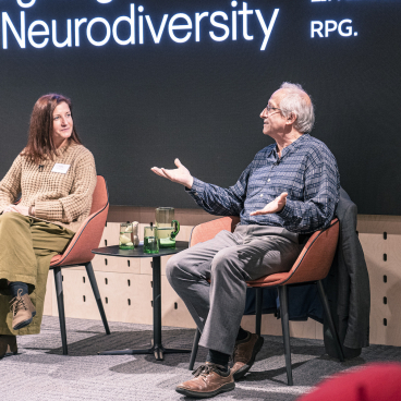 Panel discussion on neurodiversity featuring two speakers engaged in an interactive conversation at Material Source Studio event.