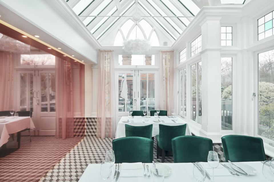 Elegant interior of Bluebells Restaurant in Ascot, featuring luxurious green velvet chairs and bright, airy decor.