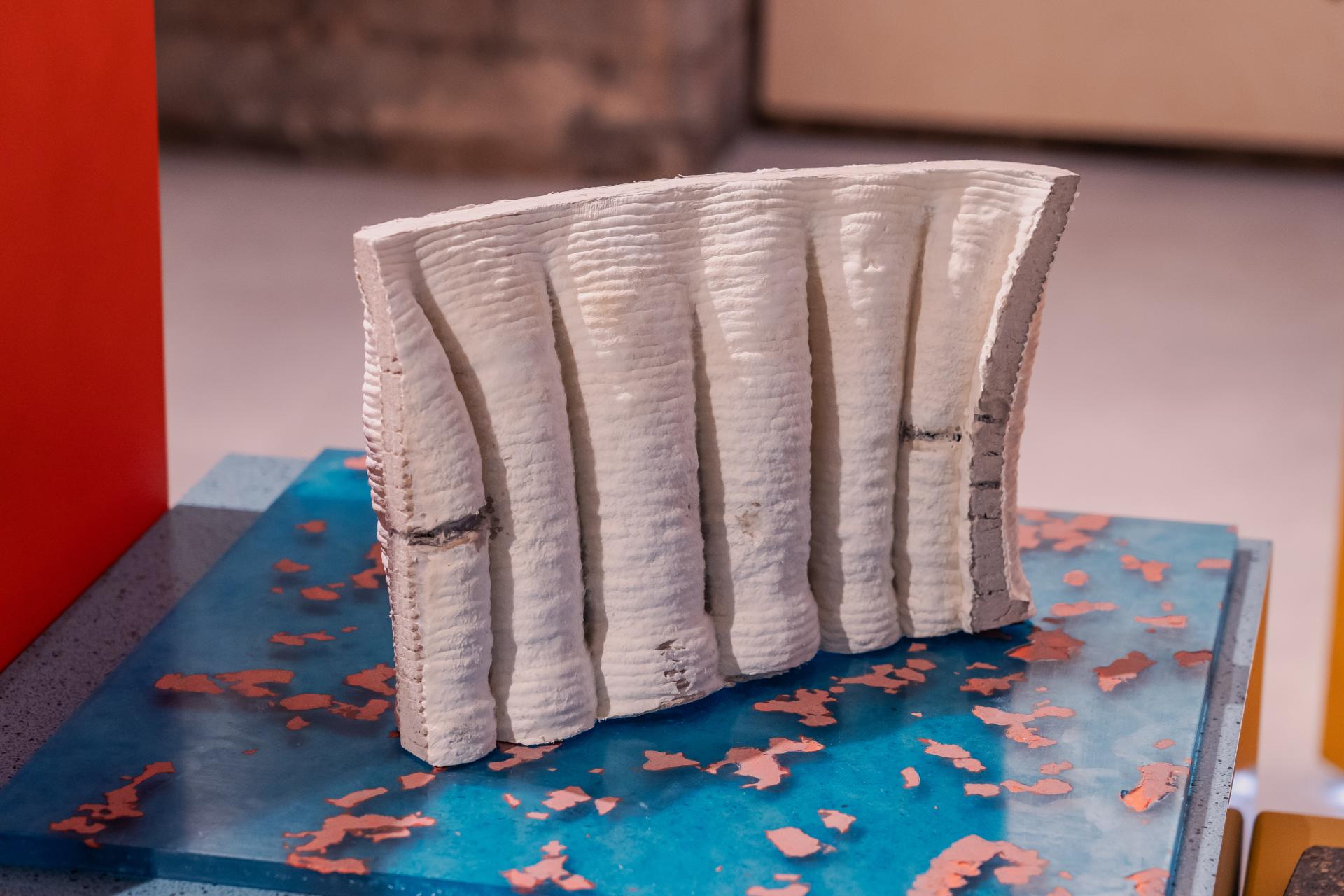 Sculptural piece made from sustainable materials, showcasing circular design principles on a colorful display surface.