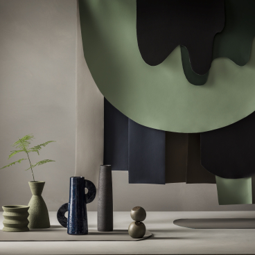Stylish display featuring Ultrafabrics' new earth-inspired colors, showcasing vases and textured fabric samples against a neutral backdrop.