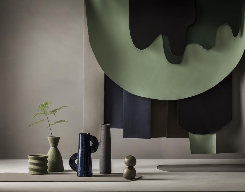 Stylish display featuring Ultrafabrics' new earth-inspired colors, showcasing vases and textured fabric samples against a neutral backdrop.