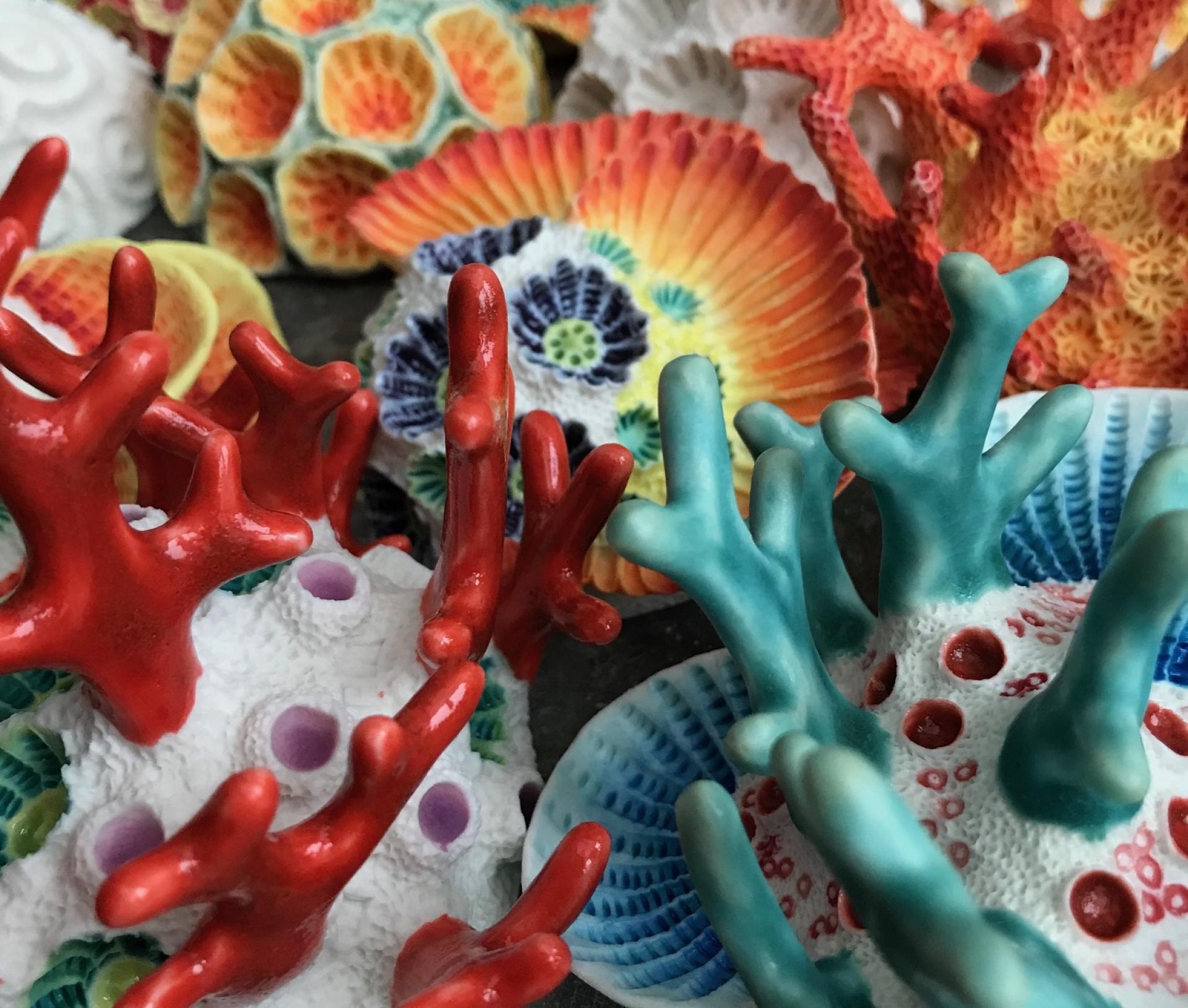 Vibrant clay sculptures of coral and shell-like forms, showcasing the beauty of the sea by Aardman Animations' sculptor.