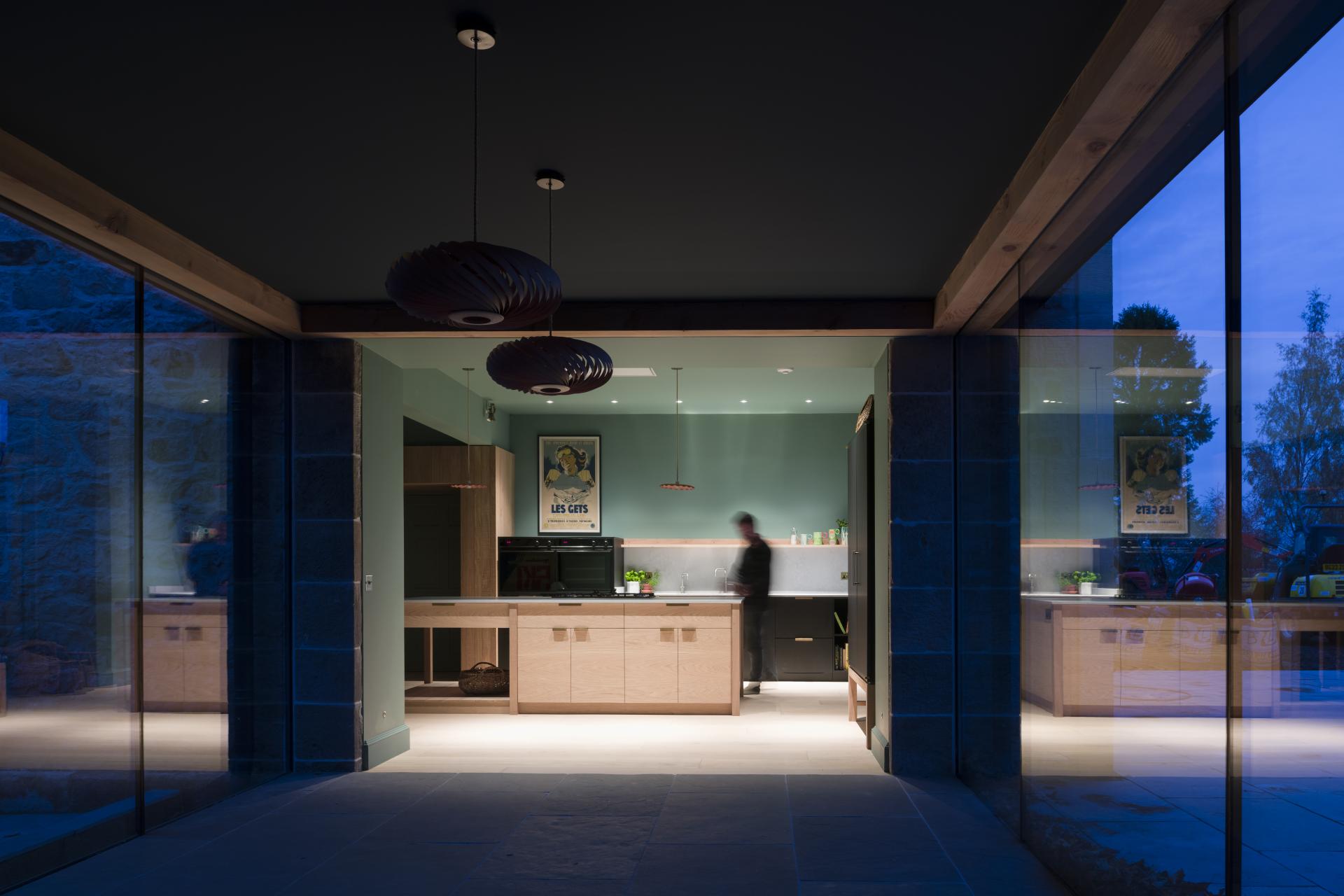 Modern kitchen featuring Caesarstone's 4044 Airy Concrete, illuminated with pendant lights, blending functionality and style in Renton Hall.