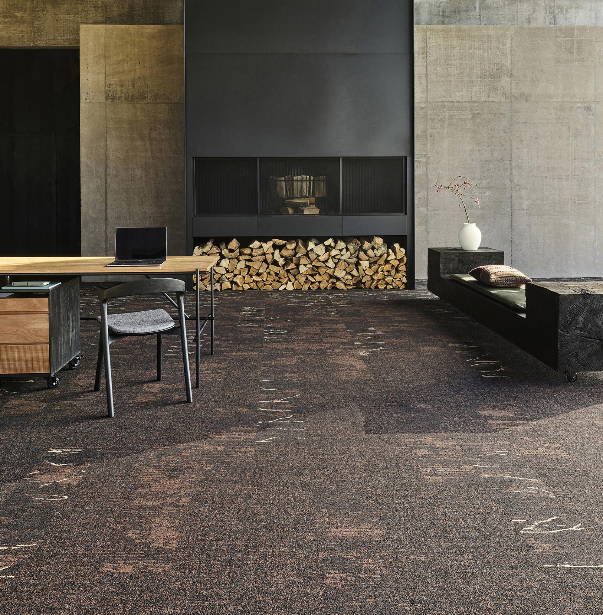 Modern living space showcasing wabi-sabi aesthetic with textured flooring, minimalist furniture, and a cozy fireplace.