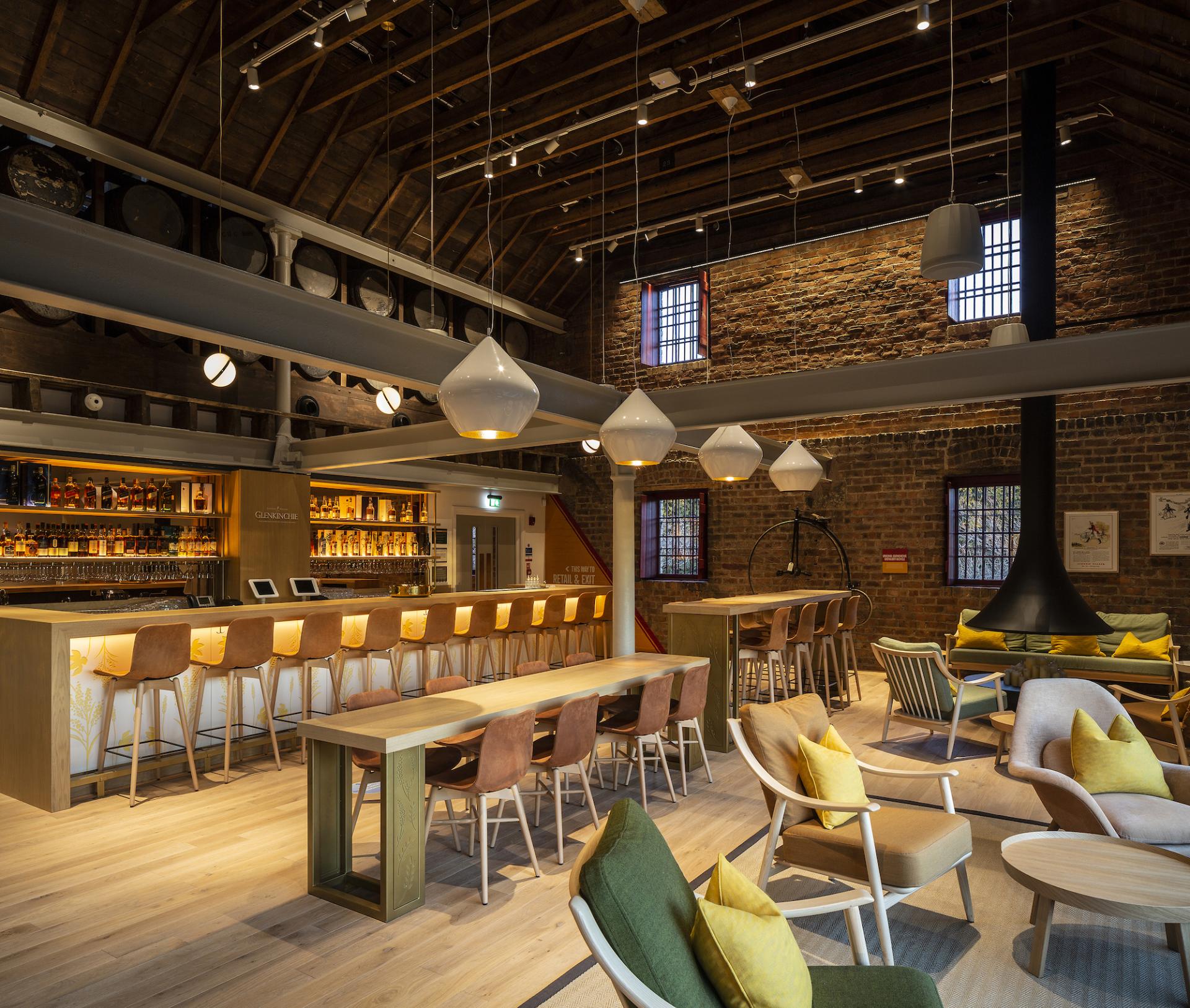Stylish interior of a whisky bar designed by Michael Laird Architects, featuring modern seating and a vibrant atmosphere.