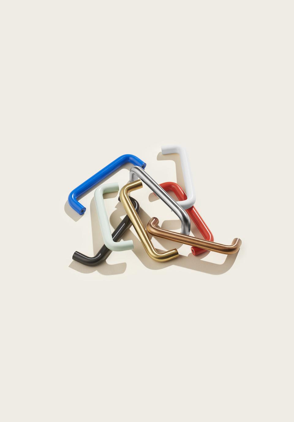 Colorful pull-handles designed by d line and &Shufl, showcasing a mix of playful designs and finishes.