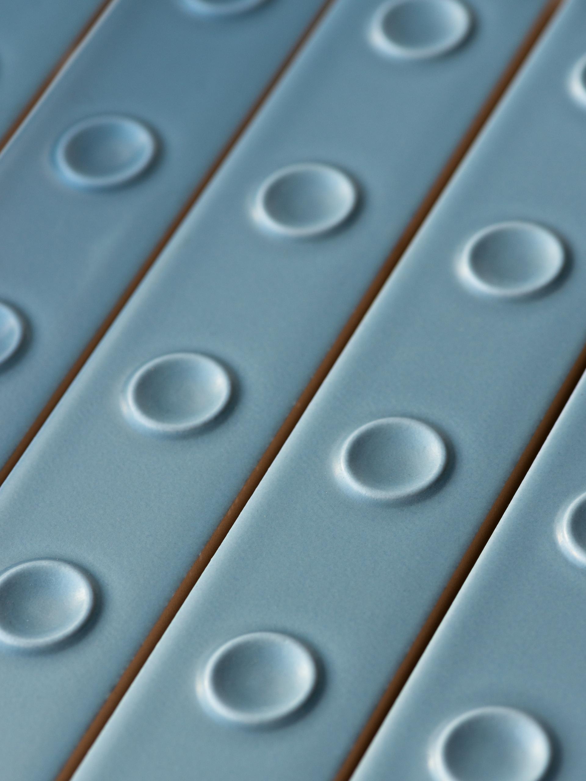 Textured ceramic tiles in soft blue tones, showcasing a unique design celebrating the collaboration between Mutina and Studio Bouroullec.