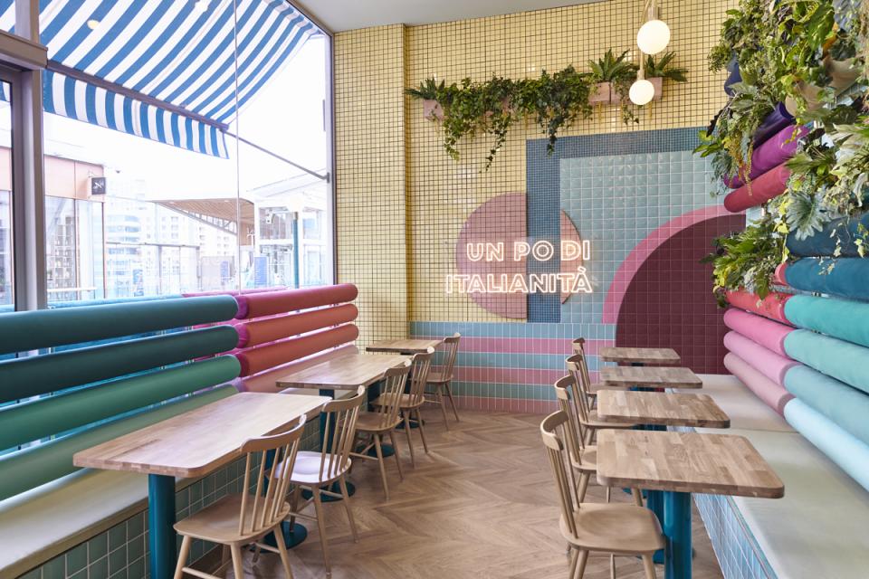 Brightly decorated interior of Piada restaurant in Lyon, featuring colorful wall tiles, modern seating, and Italian-inspired design elements.