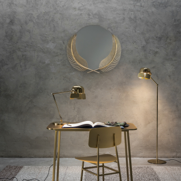 Stylish GHIDINI 1961 brass desk with a decorative mirror, task lamp, and floor lamp in a modern interior setting.