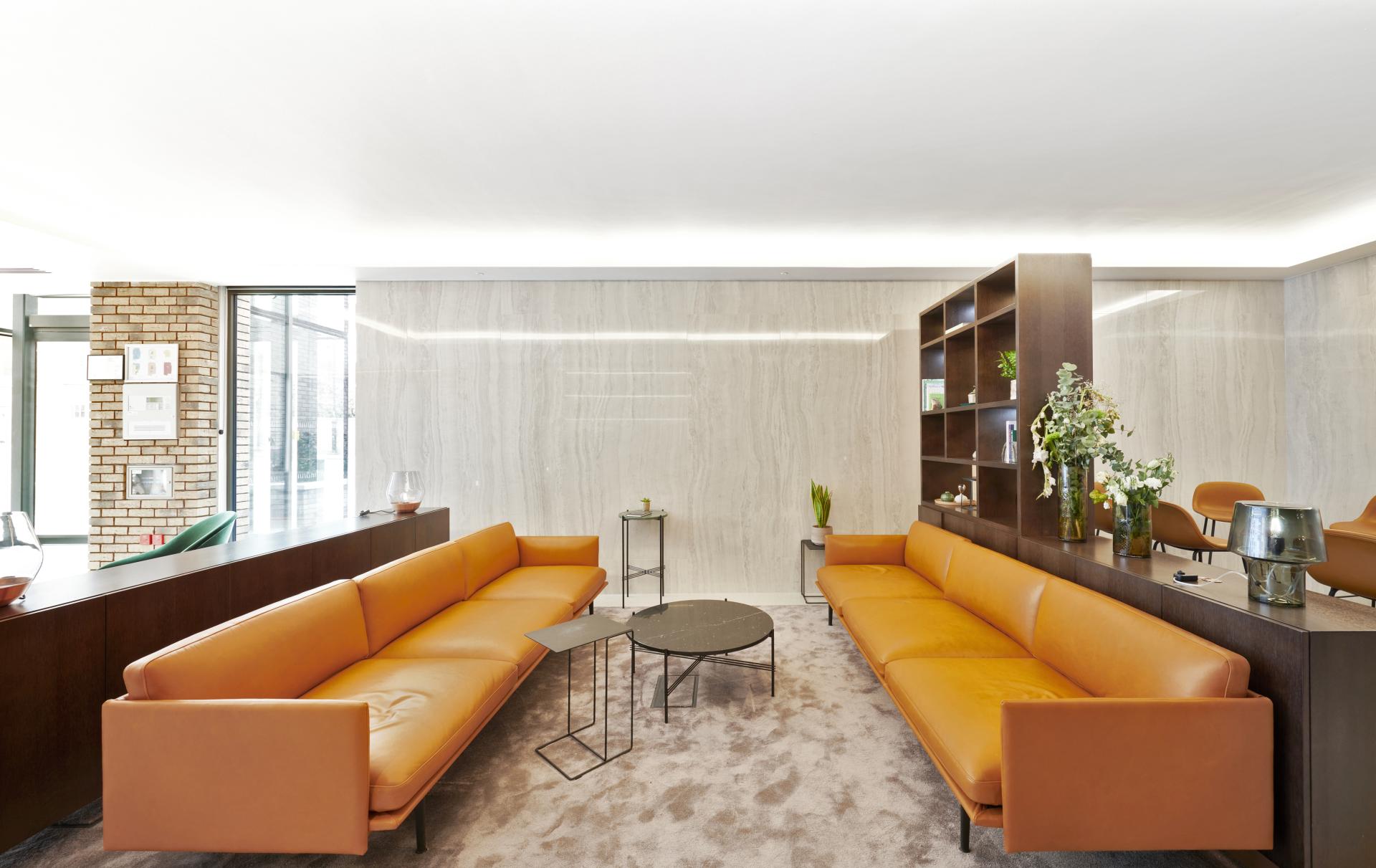 Modern interior design featuring elegant brown leather sofas, minimalist furniture, and natural decor at One Victoria Street, Windsor.