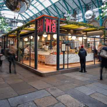 Vibrant exterior of Buns & Buns restaurant in Covent Garden, showcasing its modern design and bustling atmosphere.