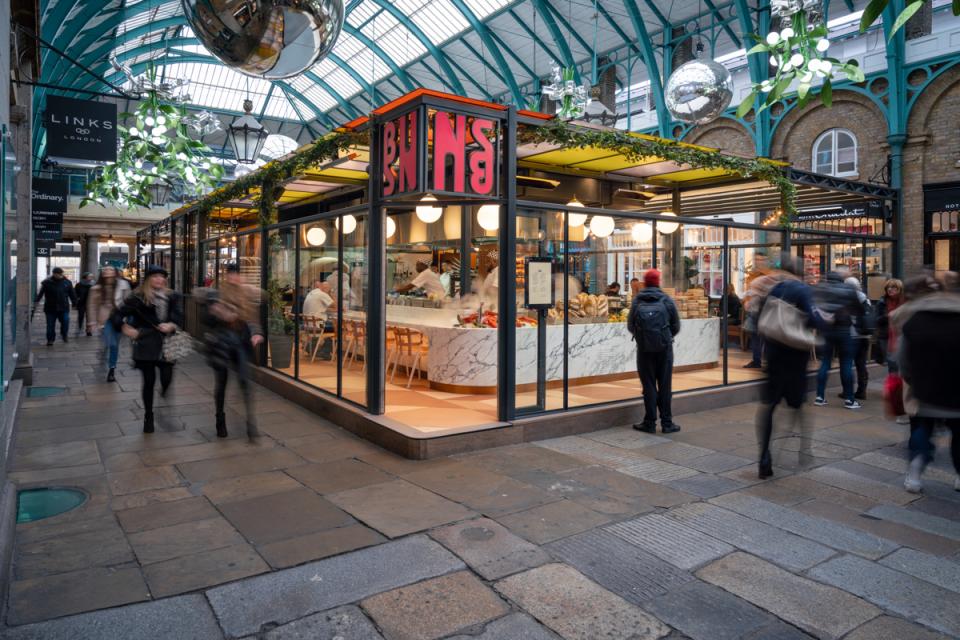 Vibrant exterior of Buns & Buns restaurant in Covent Garden, showcasing its modern design and bustling atmosphere.