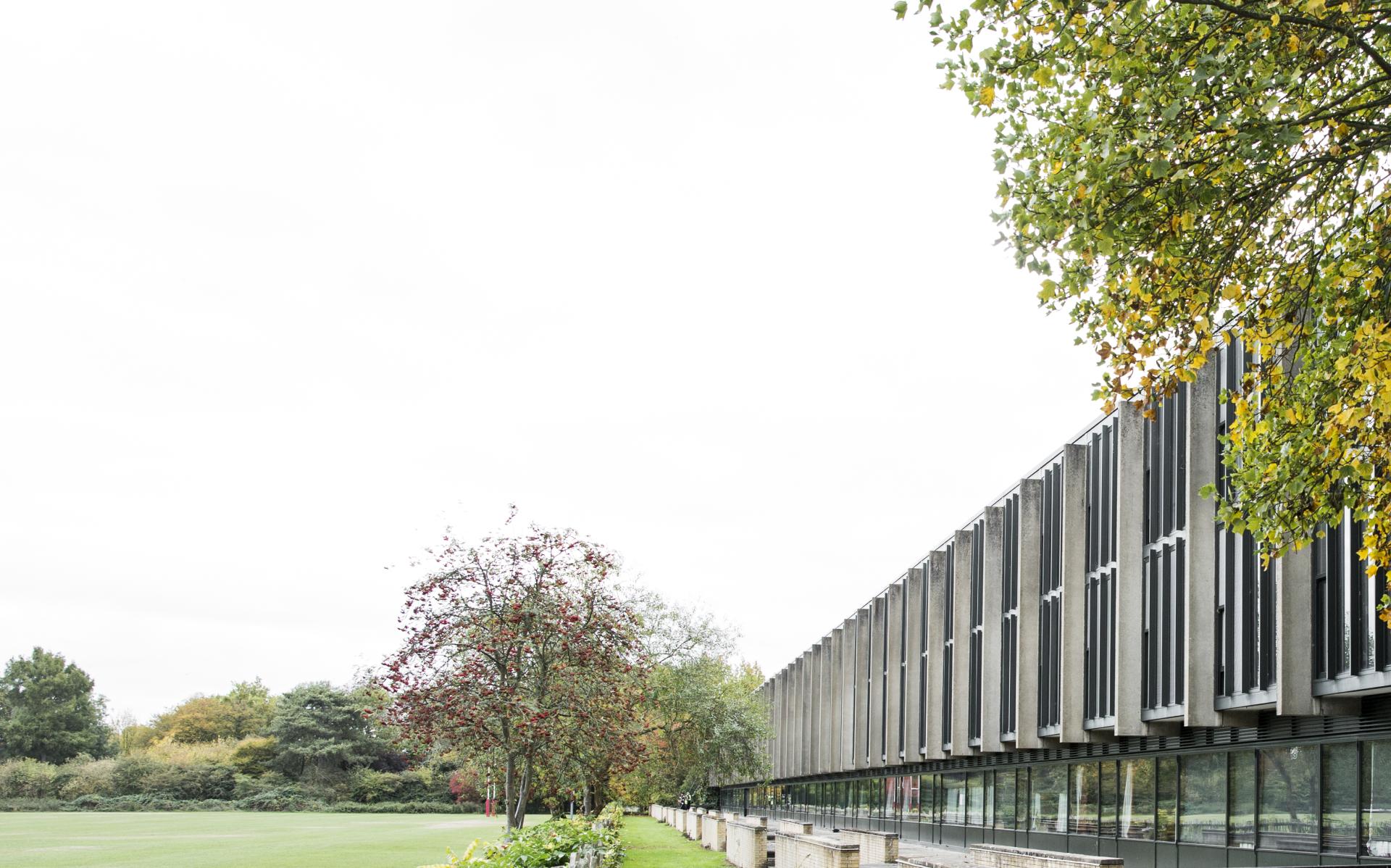 St Catherine’s College building at the University of Oxford surrounded by greenery and autumn foliage.