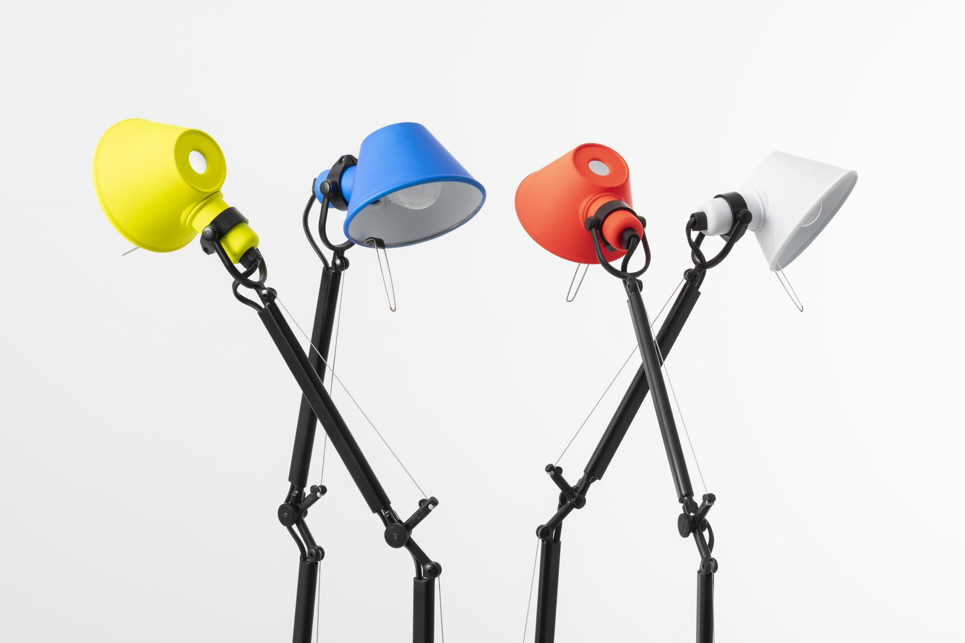 Vibrantly colored TOLOMEO Micro lamps showcasing new designs in yellow, blue, red, and white by Artemide.