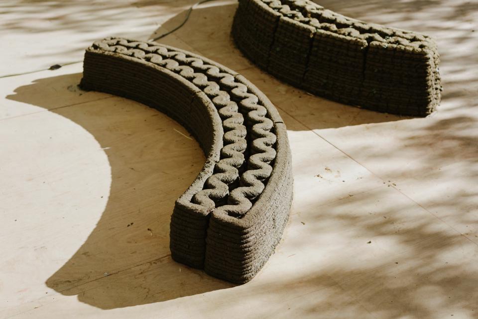 Curved sections of 3D-printed concrete structures showcased during the 'To Grow a Building' project at Jerusalem Design Week 2022.