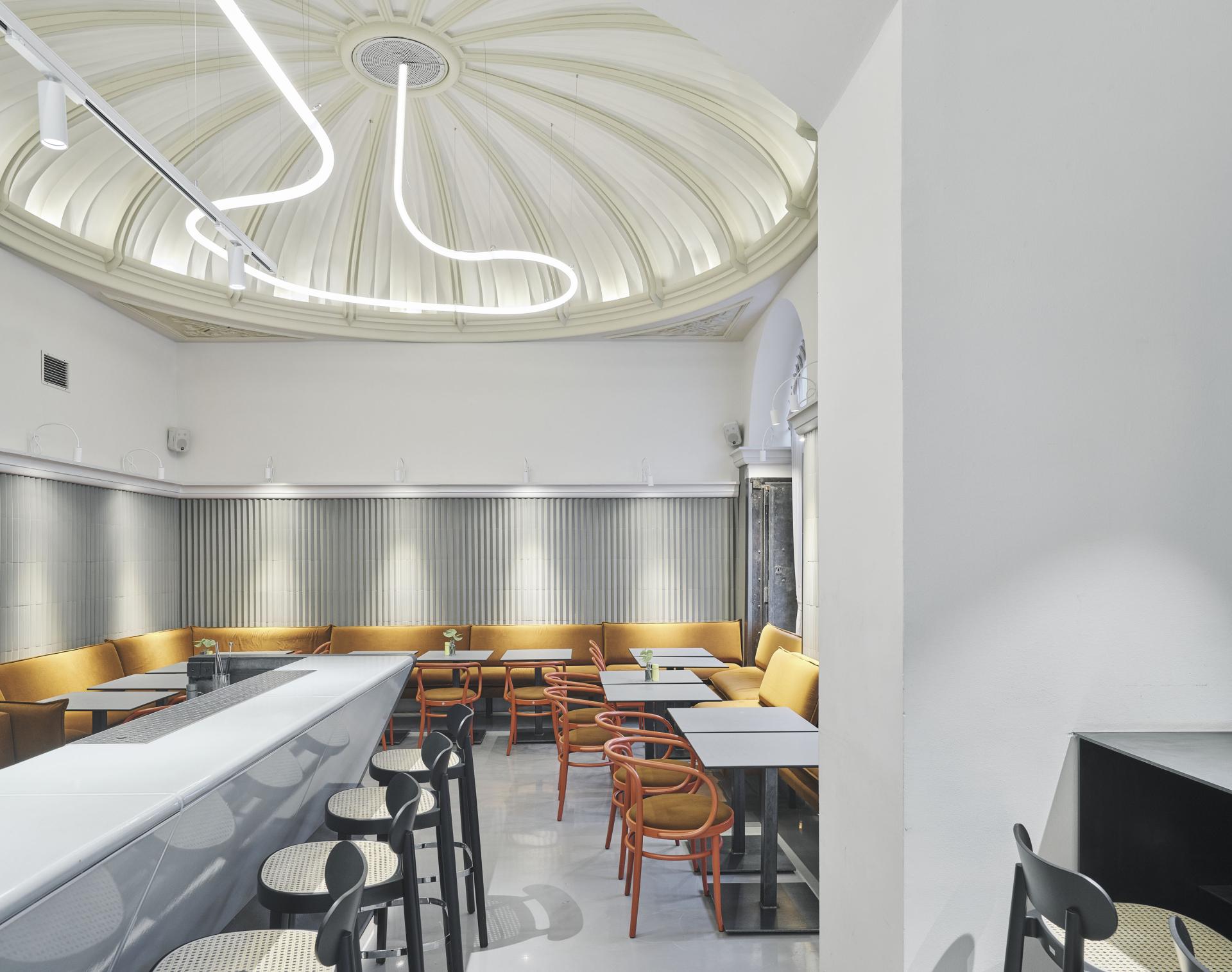 Elegant interior of Café Bellaria showcasing modern design, cozy seating, and a distinctive domed ceiling in Vienna.
