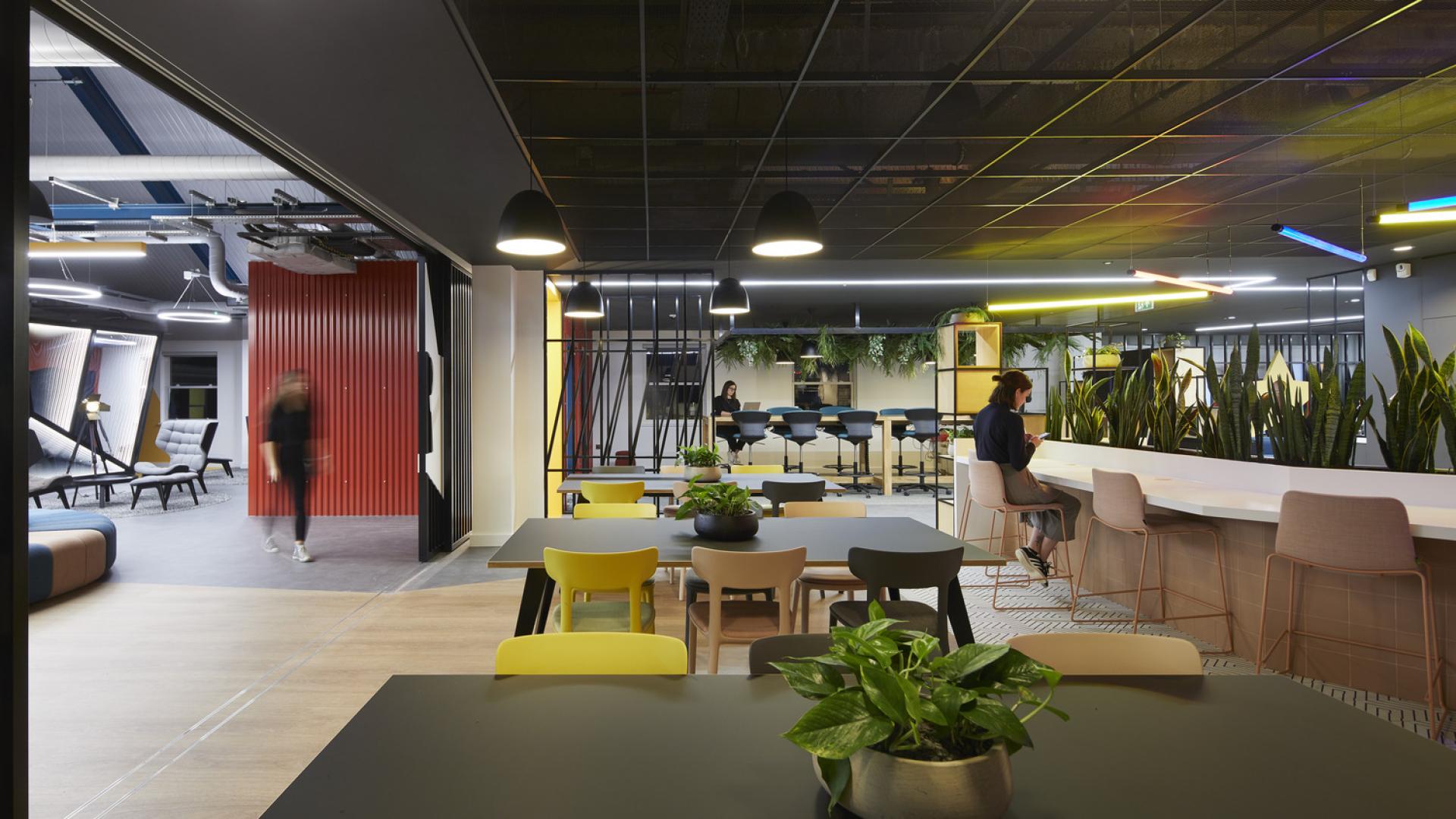 Modern workspace featuring sustainable design elements, open seating, and greenery, highlighting the creative North West community.