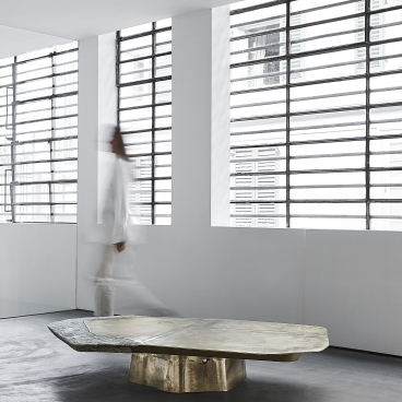 Sculptural coffee table combining opulent materials, showcased in a minimalist gallery setting by Vincenzo de Cotiis.