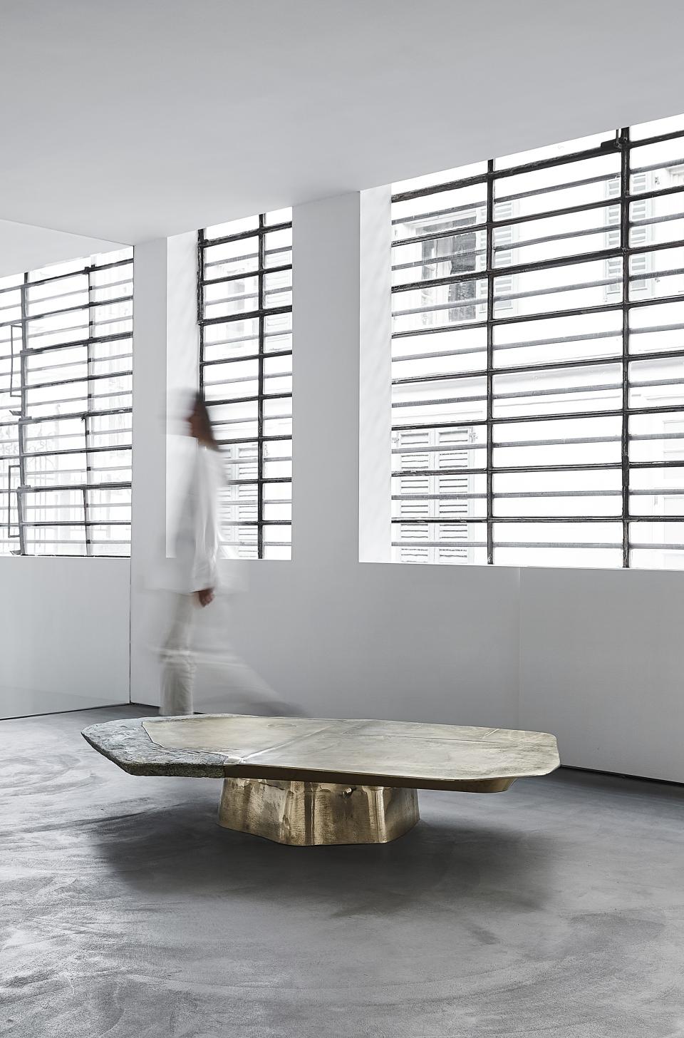 Sculptural coffee table combining opulent materials, showcased in a minimalist gallery setting by Vincenzo de Cotiis.
