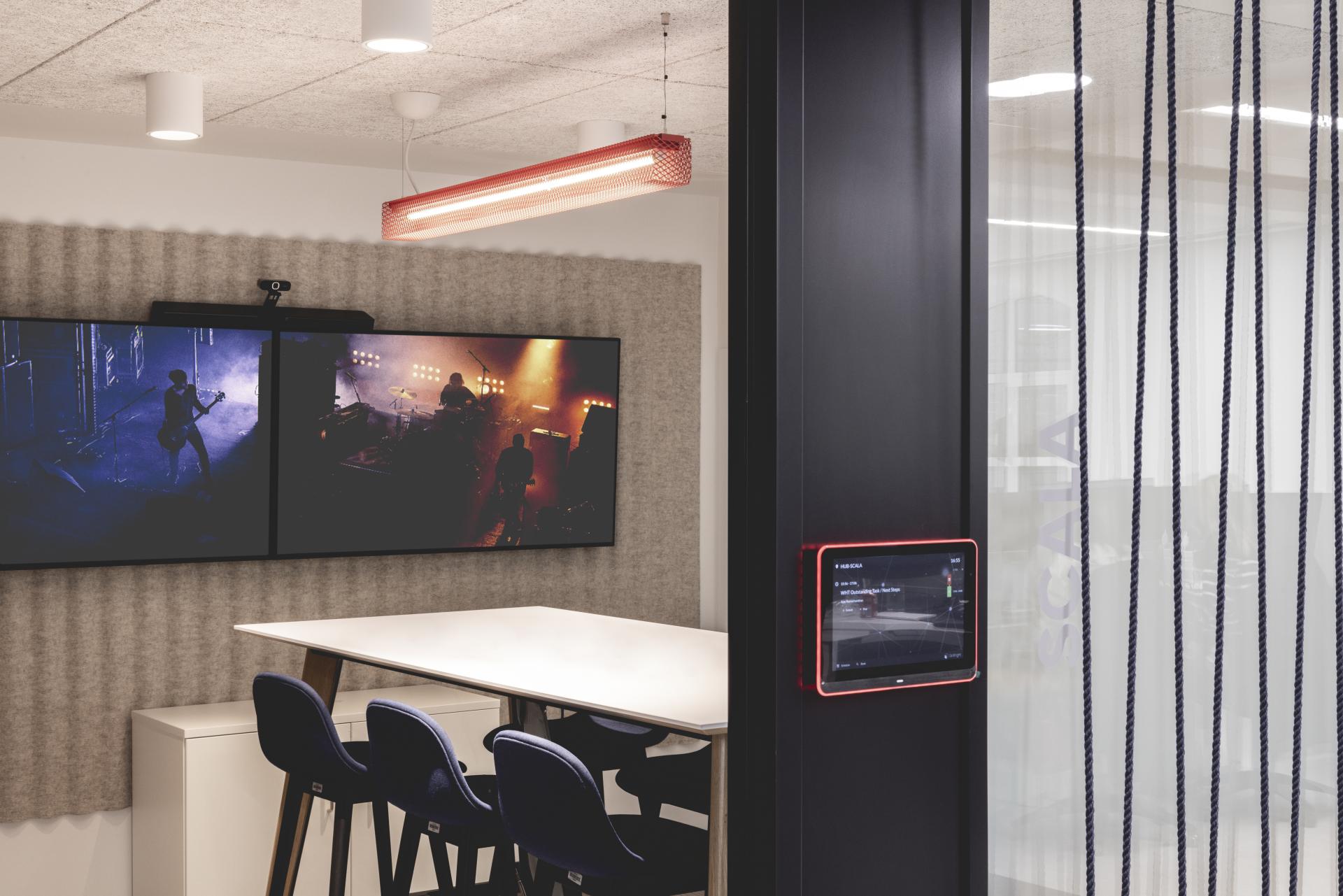Modern meeting room featuring audio-visual equipment and stylish decor, designed for PRS for Music's new London headquarters.