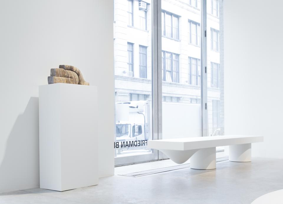 Wendell Castle's contemporary furniture displayed in a bright gallery, featuring a sculptural piece atop a white pedestal.