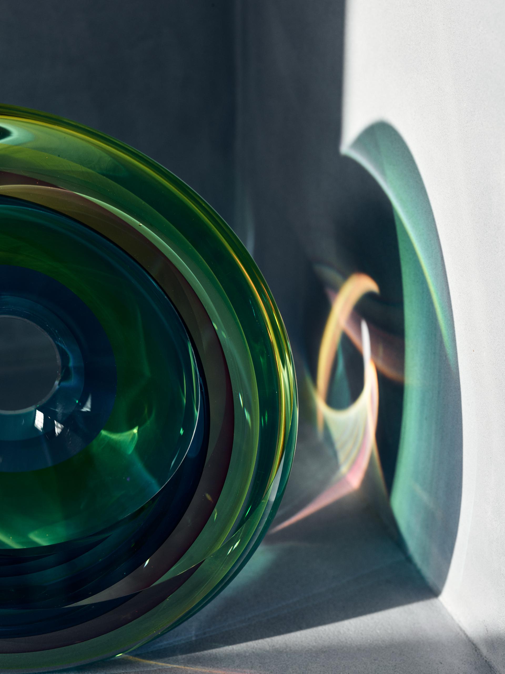 Colorful glass sculpture casting vibrant reflections, showcasing contemporary craft artistry at Collect exhibition in Somerset House.