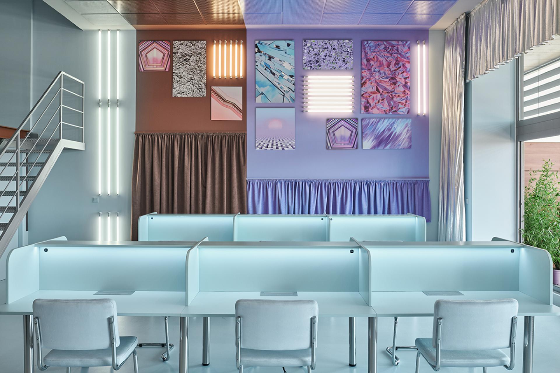 Bright and modern coworking space in Valencia featuring artistic decor, minimalist desks, and vibrant lighting for creative collaboration.