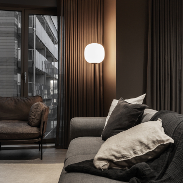 Modern living room in Manchester featuring cozy furniture, stylish lighting, and warm curtains, reflecting contemporary design.