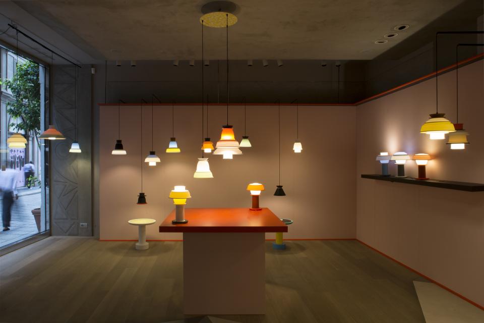 Colorful SHADES lamps displayed in a modern showroom, highlighting versatile configurations and contemporary design elements.