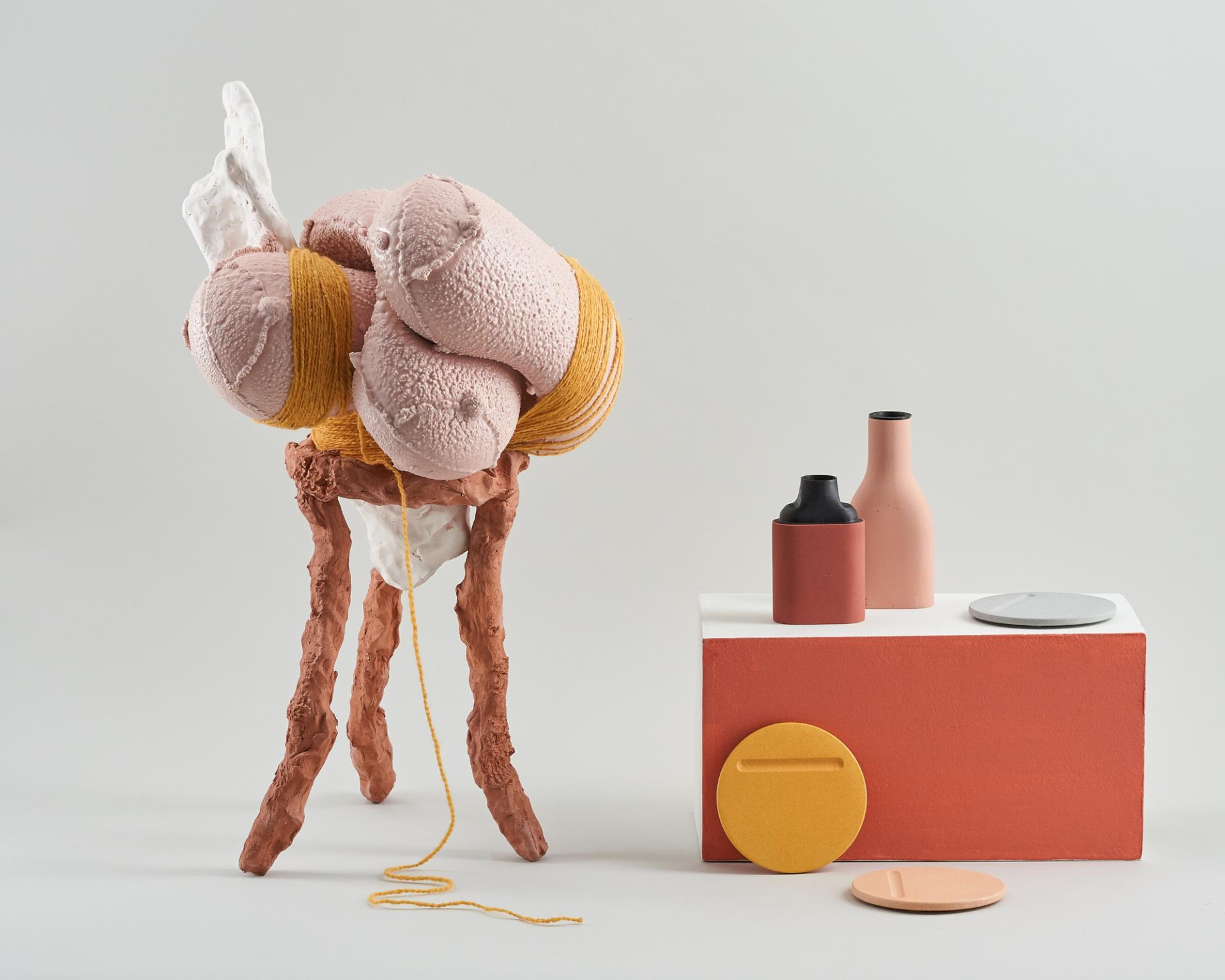 Colorful sculptural art piece featuring textured forms and ceramic vessels, representing innovative design at New Designers 2019.