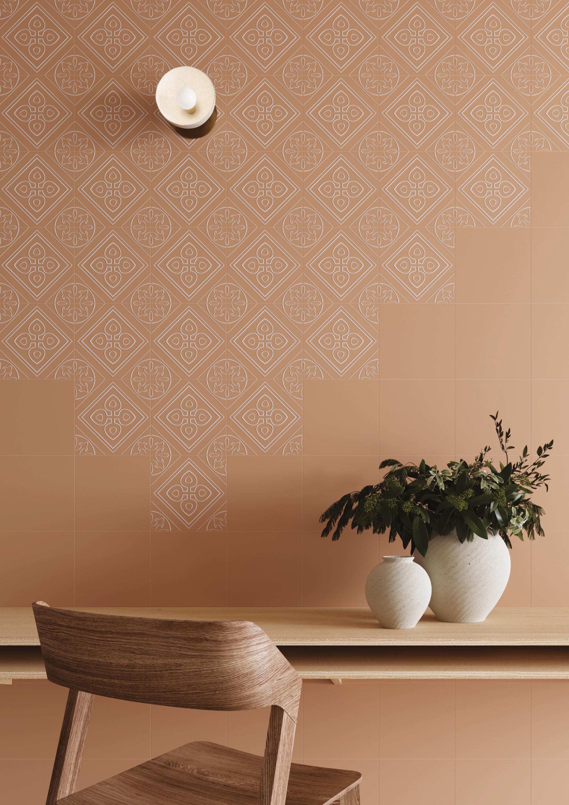 Porcelain tiles from Grestec's Silence Collection featuring elegant patterns, complemented by decorative vases and wooden furniture.