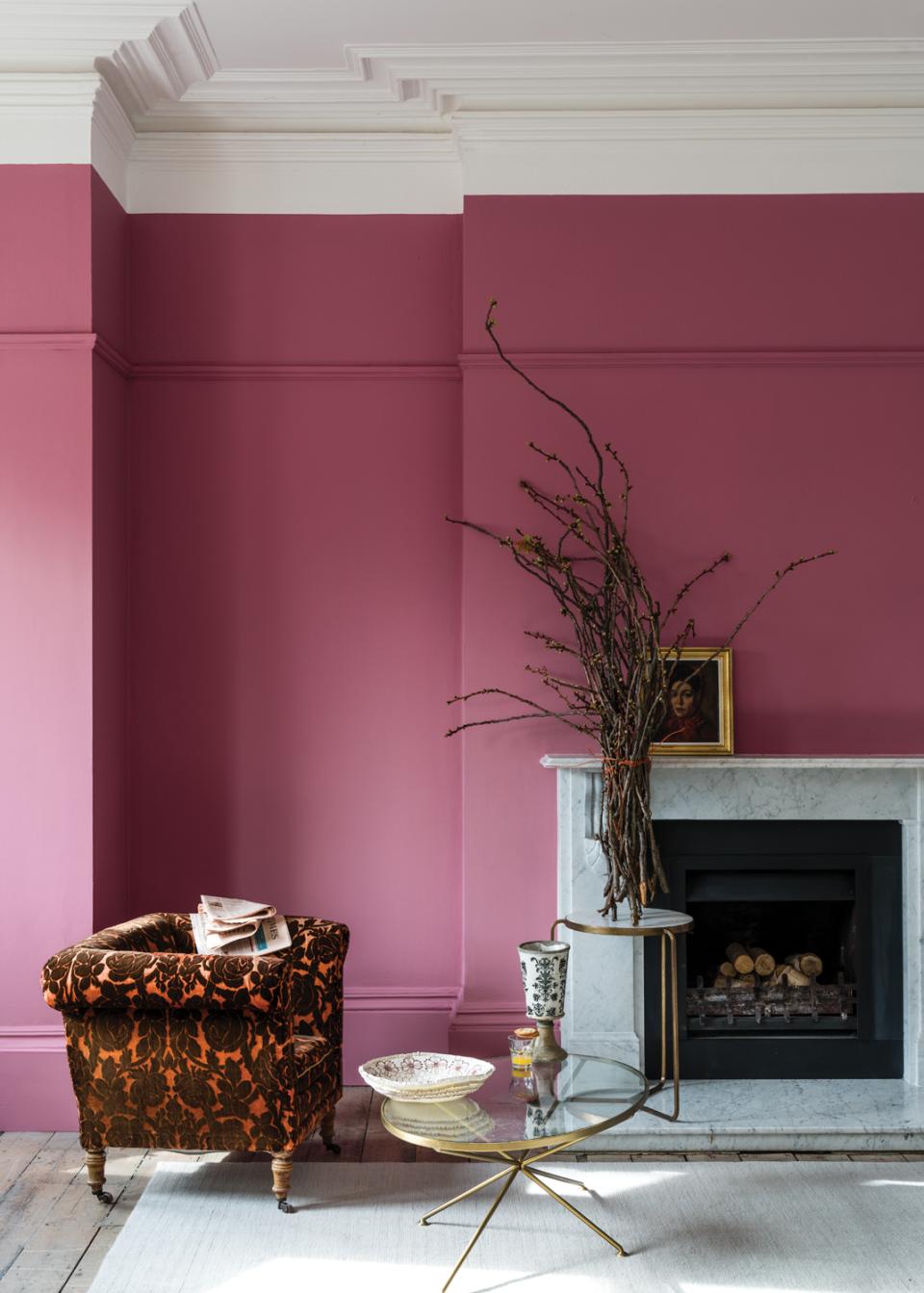 Cozy interior featuring Farrow & Ball's Sulking Room Pink, accented by vintage furniture and artistic decor elements.