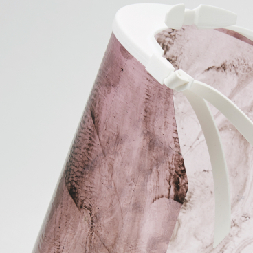 Biodegradable personal protective equipment designed by Alice Potts, showcasing a sleek, transparent design with a pink tint.