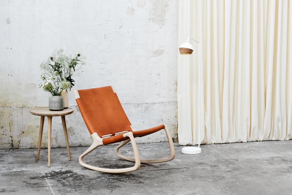 Elegant rocking chair by Mater, designed by Shawn Place, featuring natural wood and soft leather in a modern setting.
