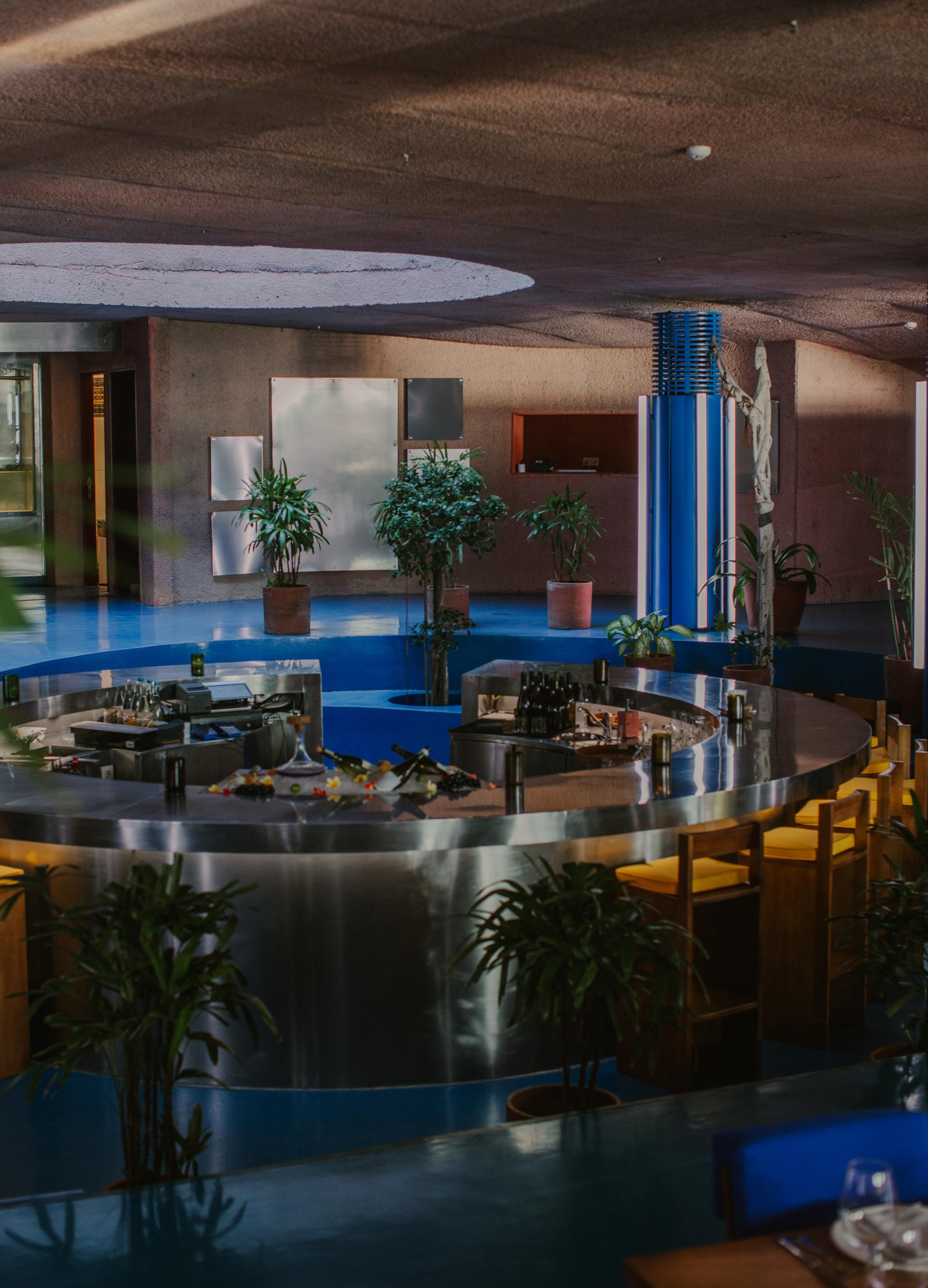 Futuristic interior of Dome restaurant at Desa Potato Head, featuring neon accents, earthy designs, and sustainable decor elements.