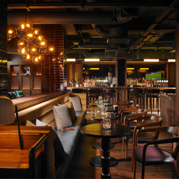 Stylish bar interior at The Mont Hotel in Dublin, featuring modern lighting and contemporary seating arrangements.