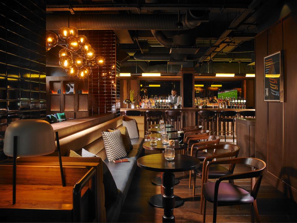 Stylish bar interior at The Mont Hotel in Dublin, featuring modern lighting and contemporary seating arrangements.