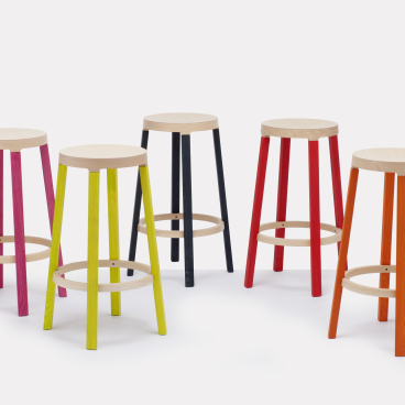 Contemporary wooden bar stools in vibrant colors, part of Established & Sons' new seating collection.