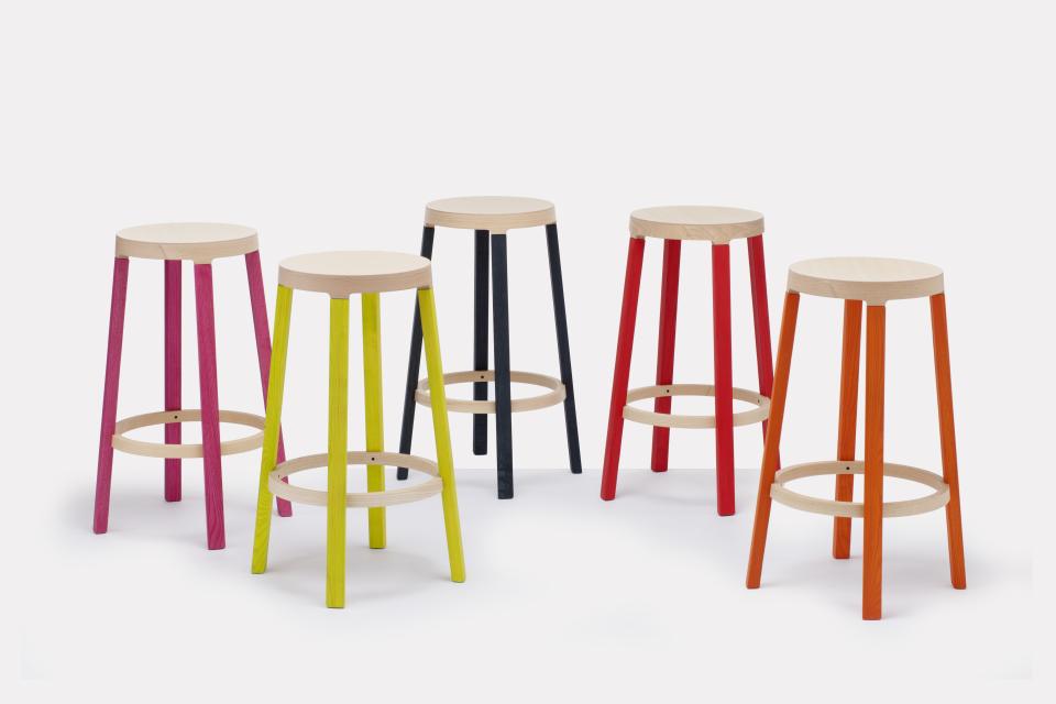 Contemporary wooden bar stools in vibrant colors, part of Established & Sons' new seating collection.